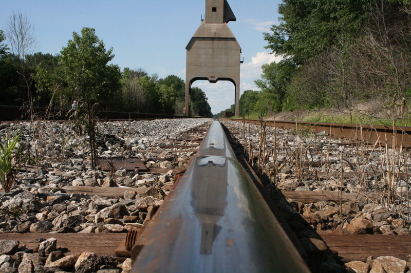 Railroad tracks leading to a water tower