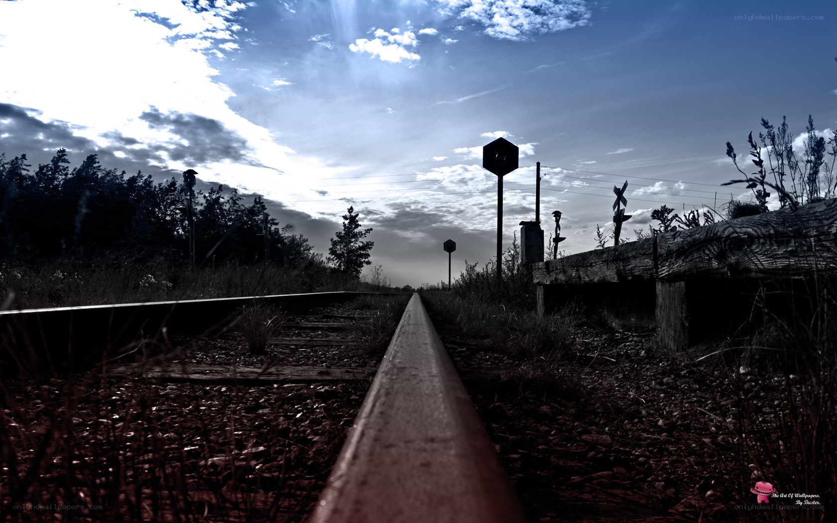 Railroad tracks under cloudy sky