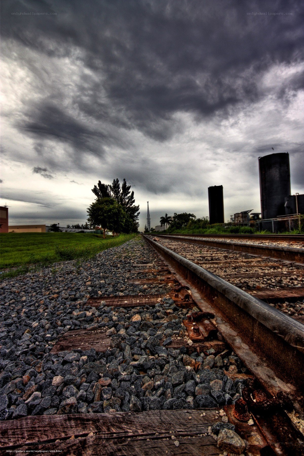 Railroad tracks under stormy sky