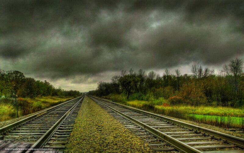 railroad under stormy sky