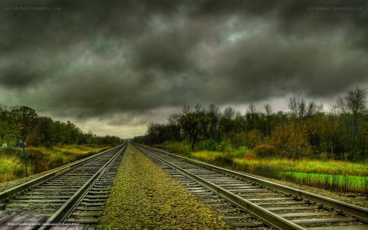 railroad under stormy sky