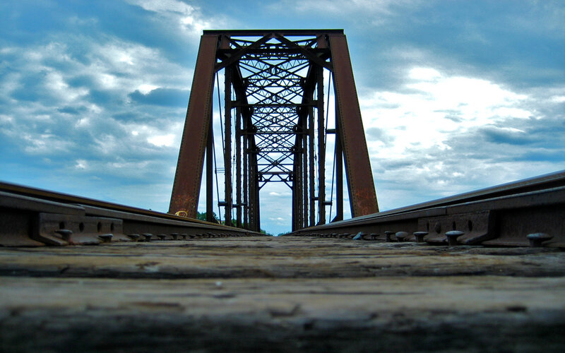 railway bridge under cloudy sky
