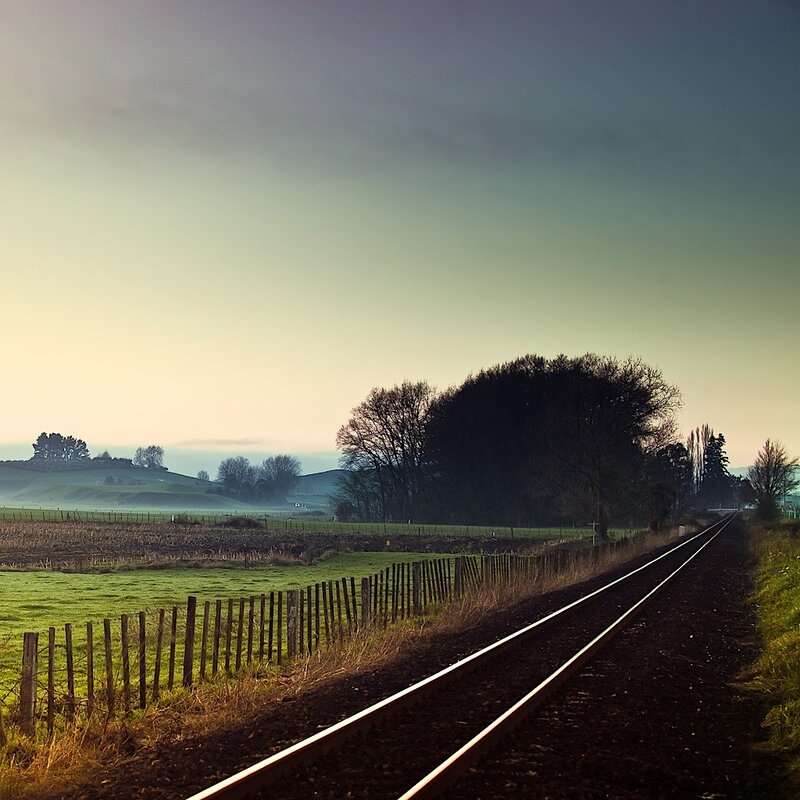 Railway track through green fields