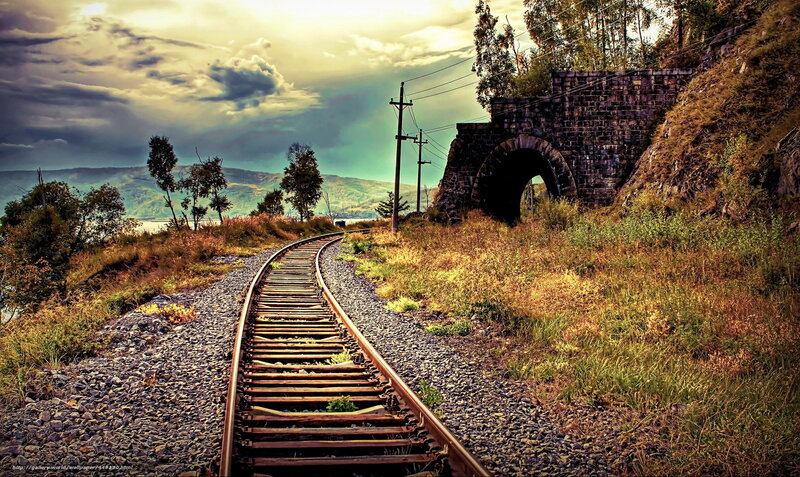 Railway track through stone arch