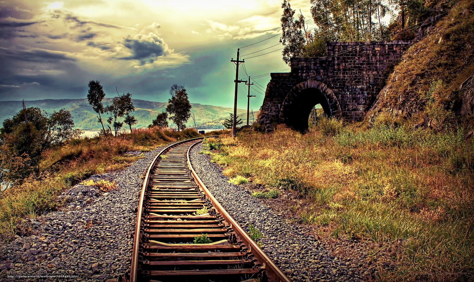 Railway track through stone arch