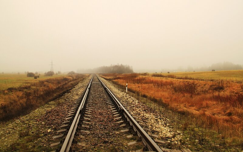 Railway tracks in a foggy field