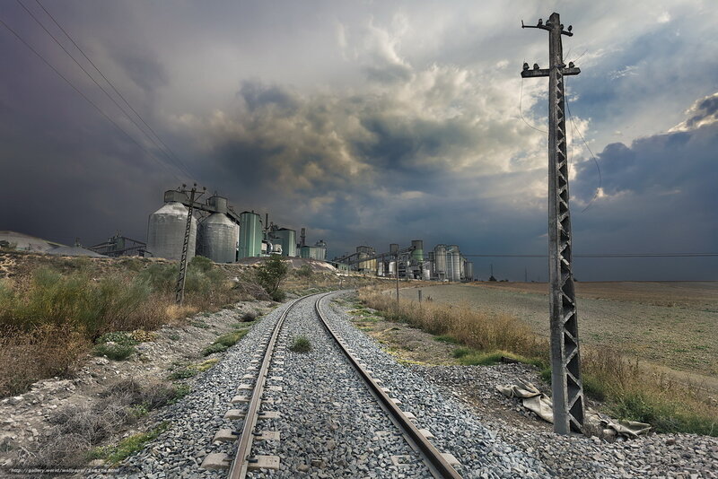 Railway tracks leading to industrial silos