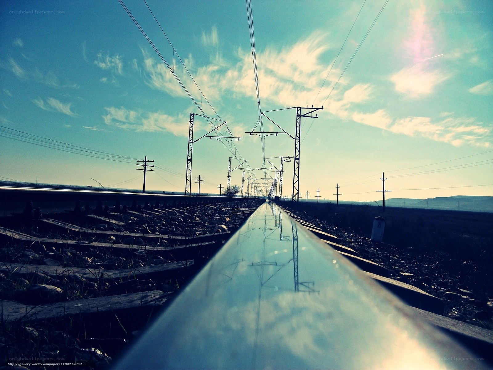 Railway tracks under a blue sky
