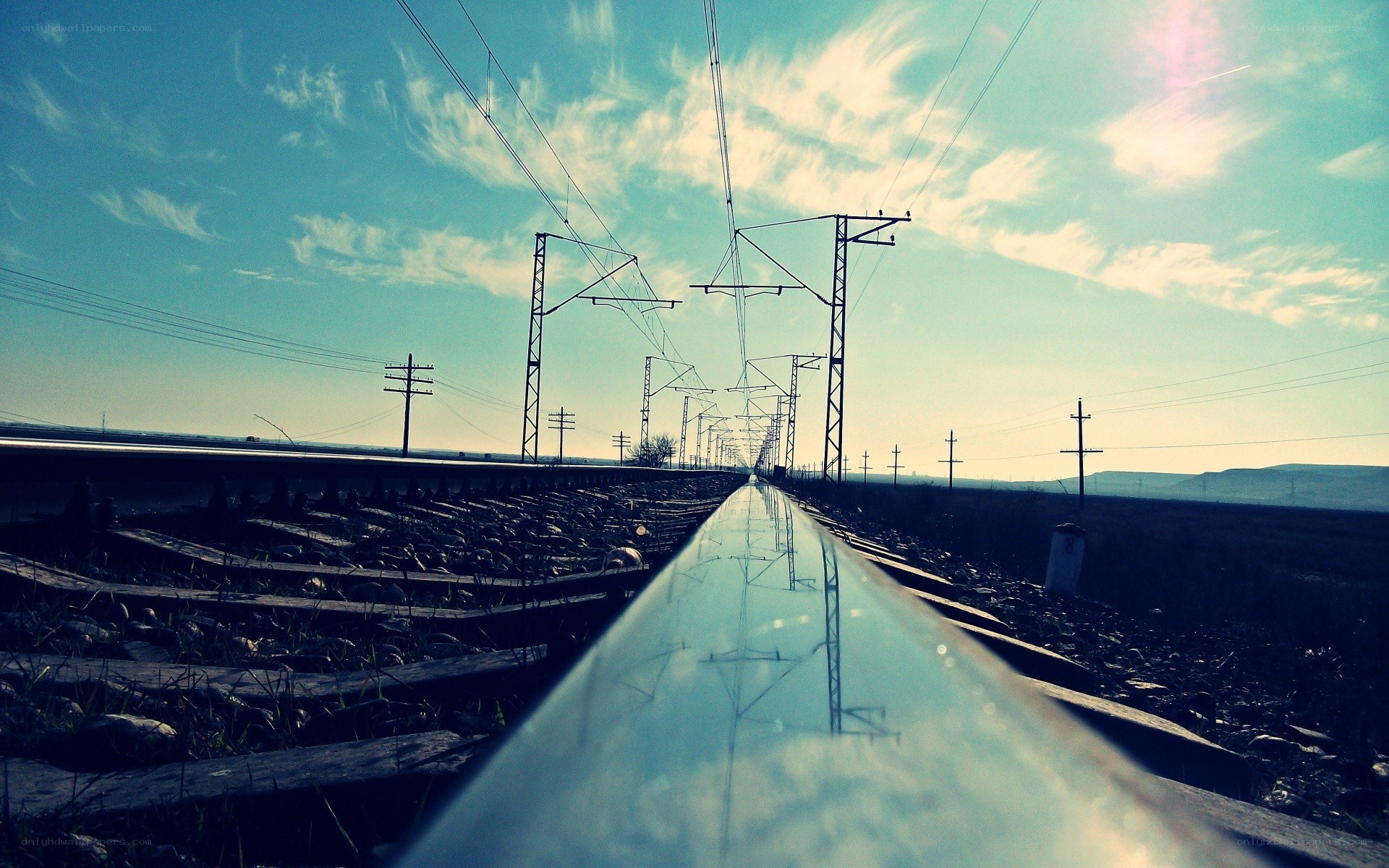 Railway tracks under a cloudy sky