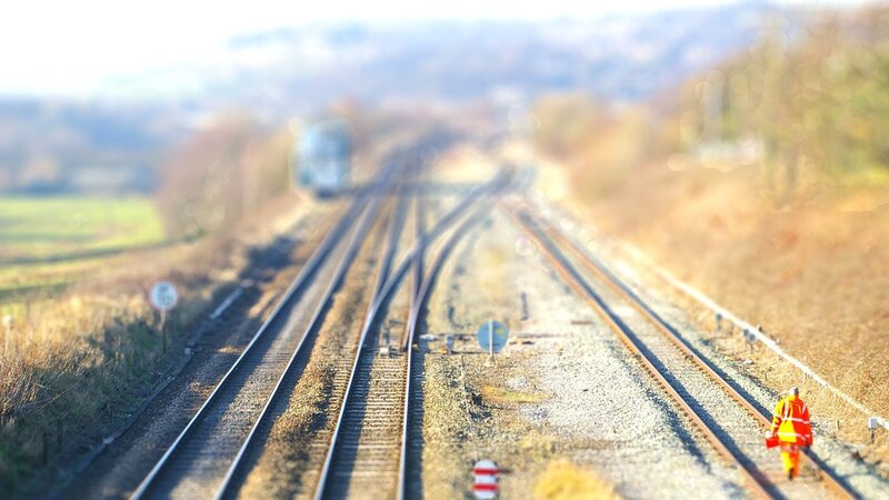 Railway Worker on Tracks — Brown