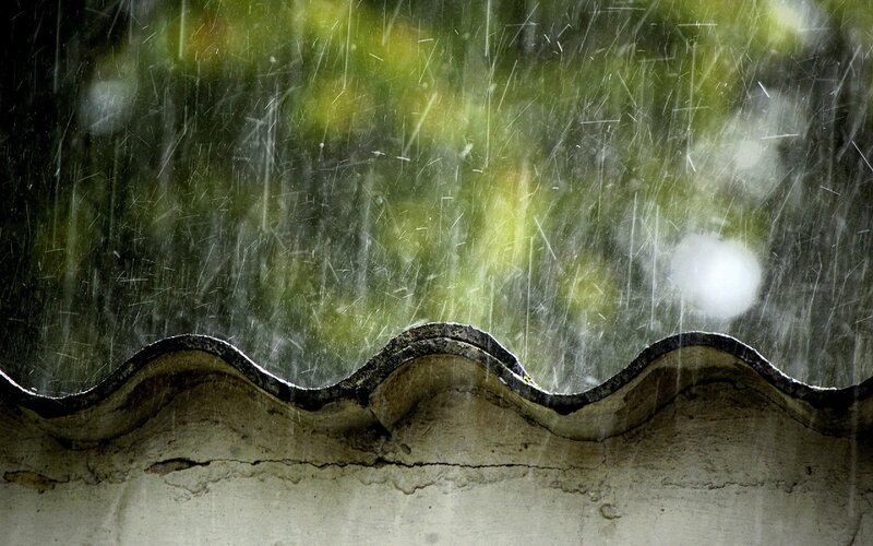 Rain falling on a roof edge