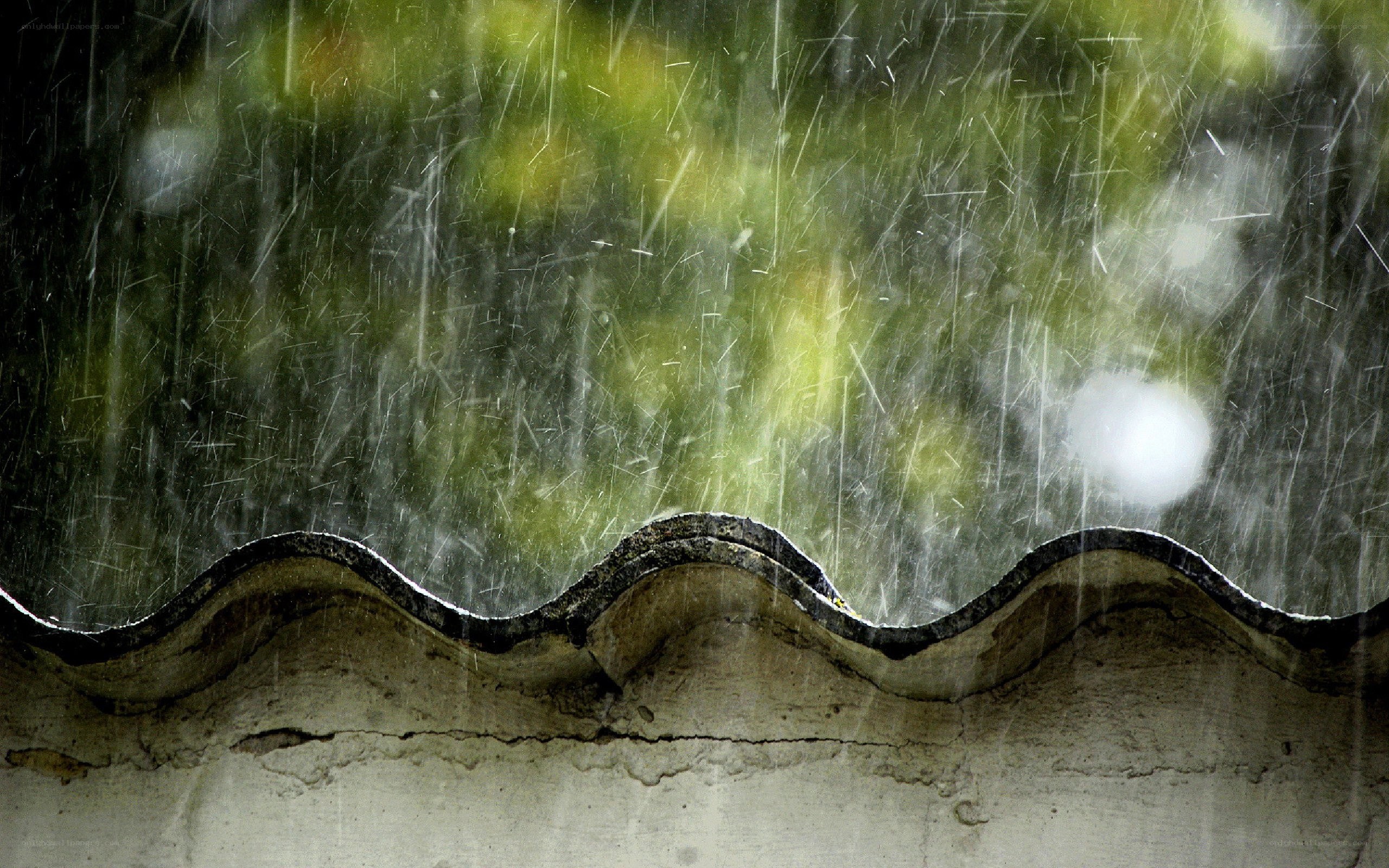 Rain falling on a roof edge