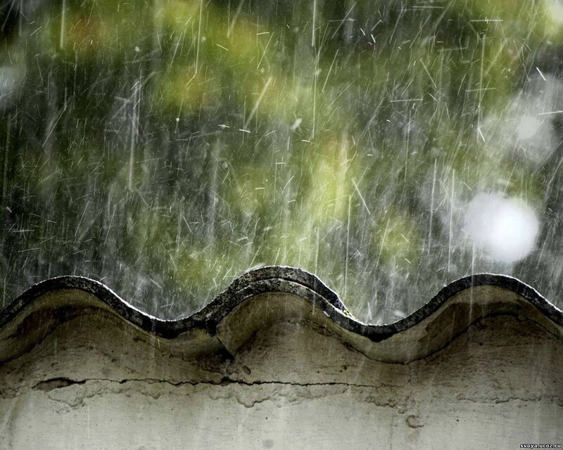 Rain falling on a roof edge