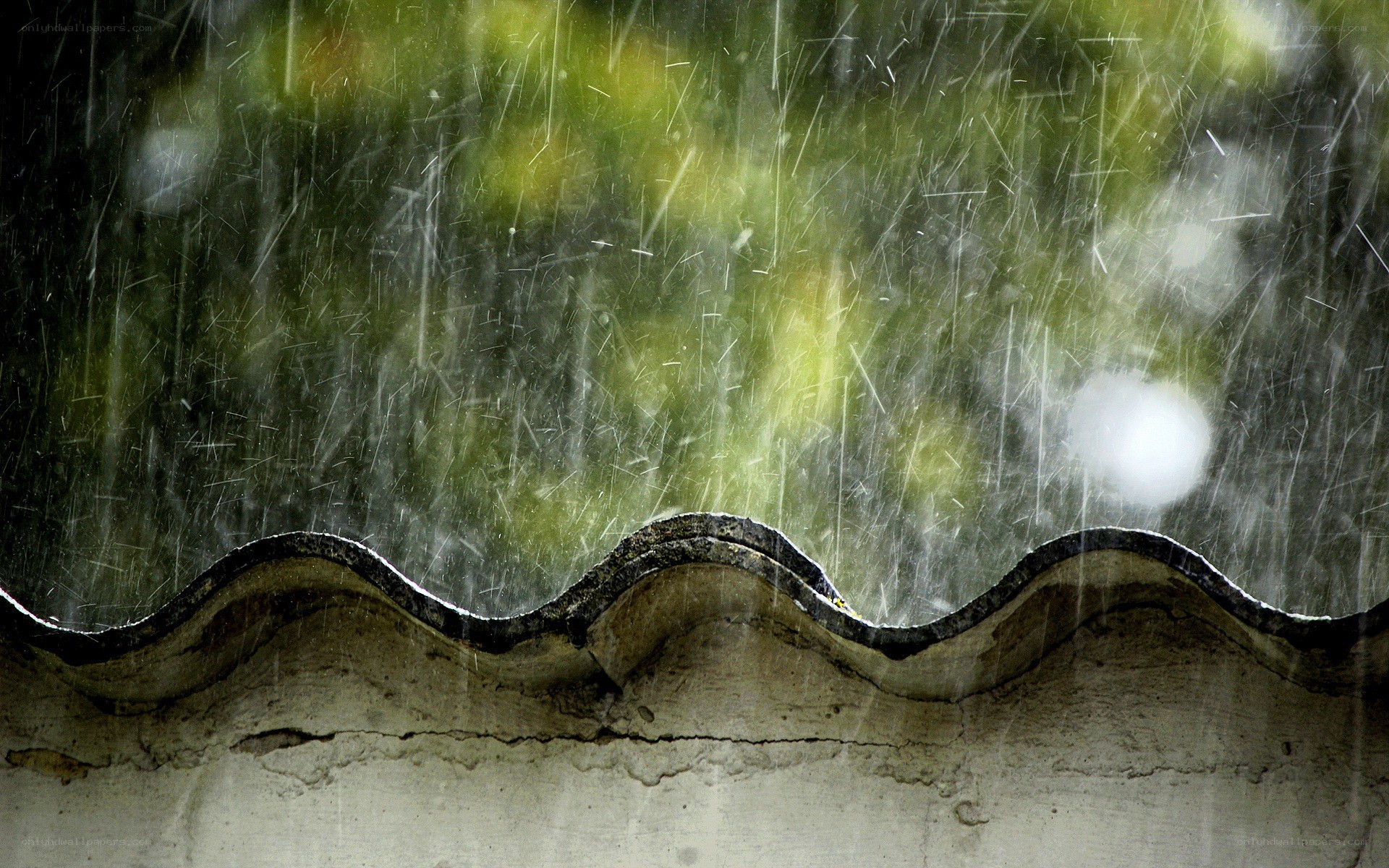 Rain falling on a roof edge