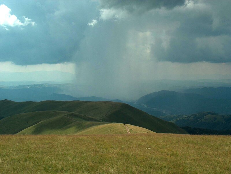 Rain over rolling hills