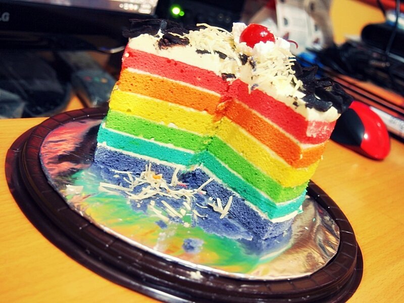 Rainbow cake slice on a plate