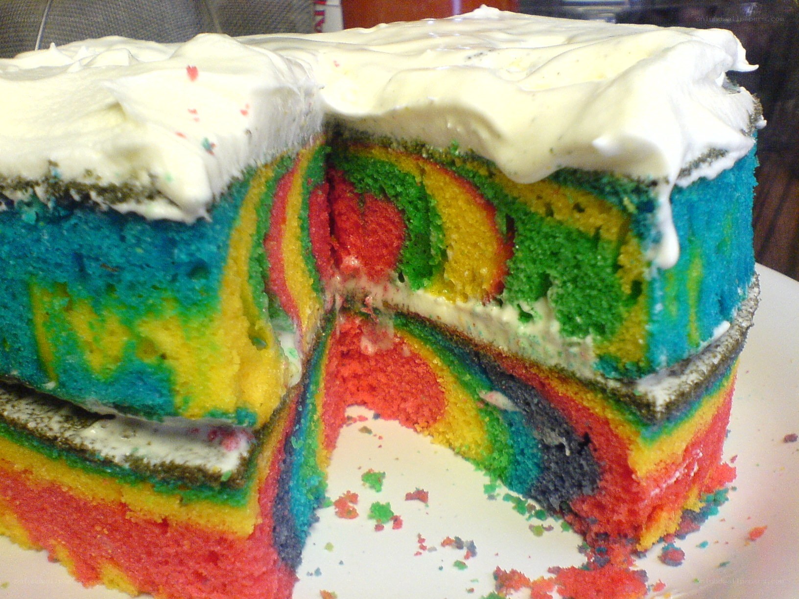 rainbow cake with white frosting