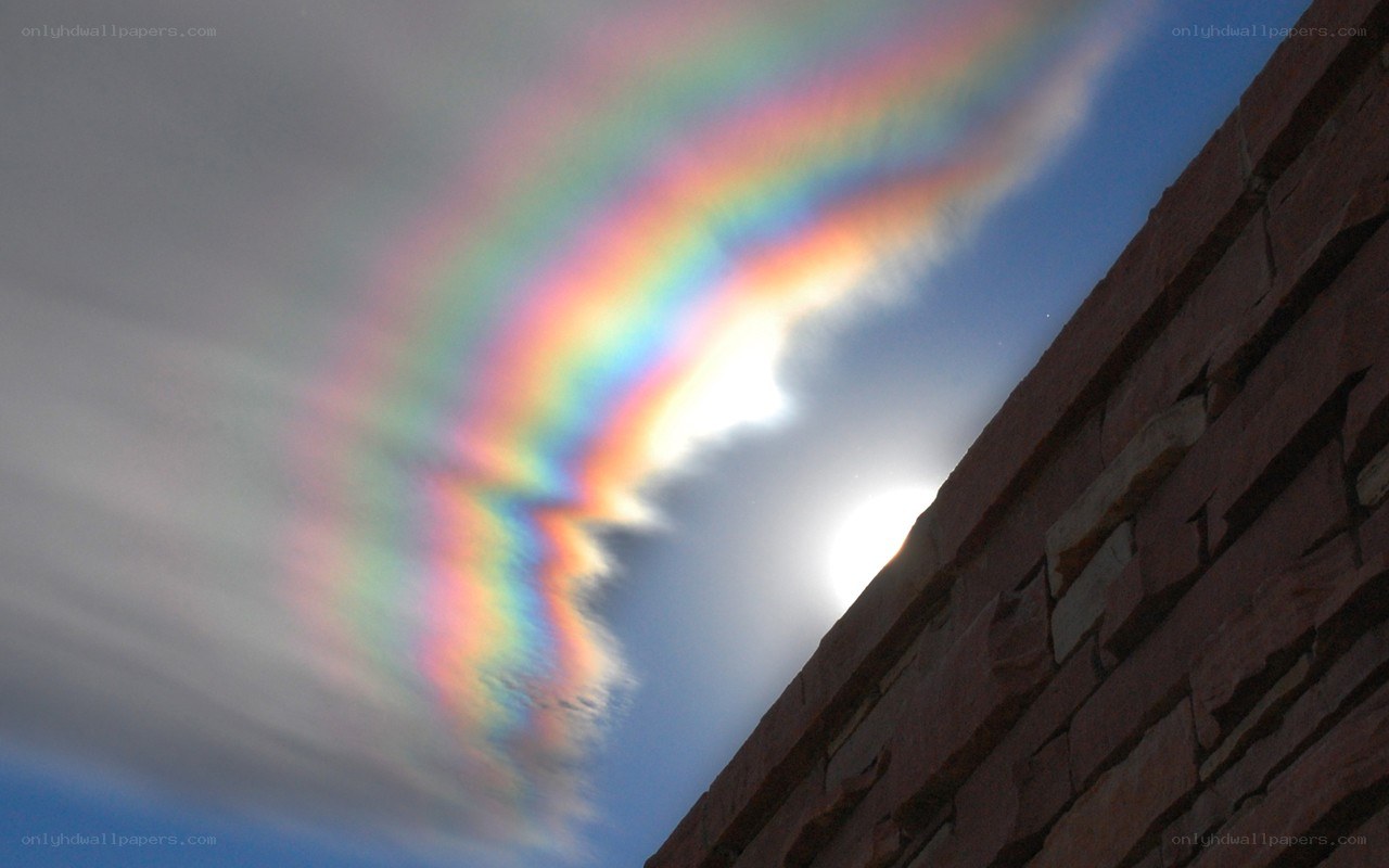 rainbow cloud over brick wall