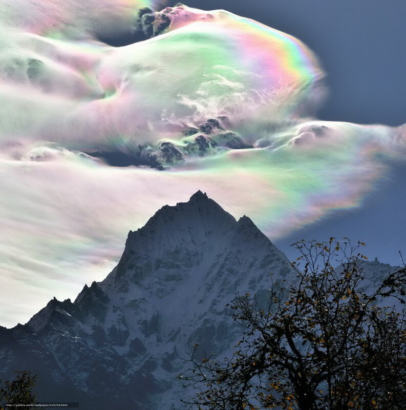 Rainbow cloud over mountain peak