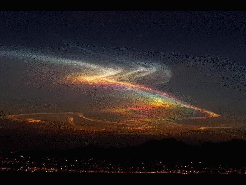 rainbow clouds over city