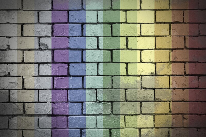 rainbow flag on brick wall