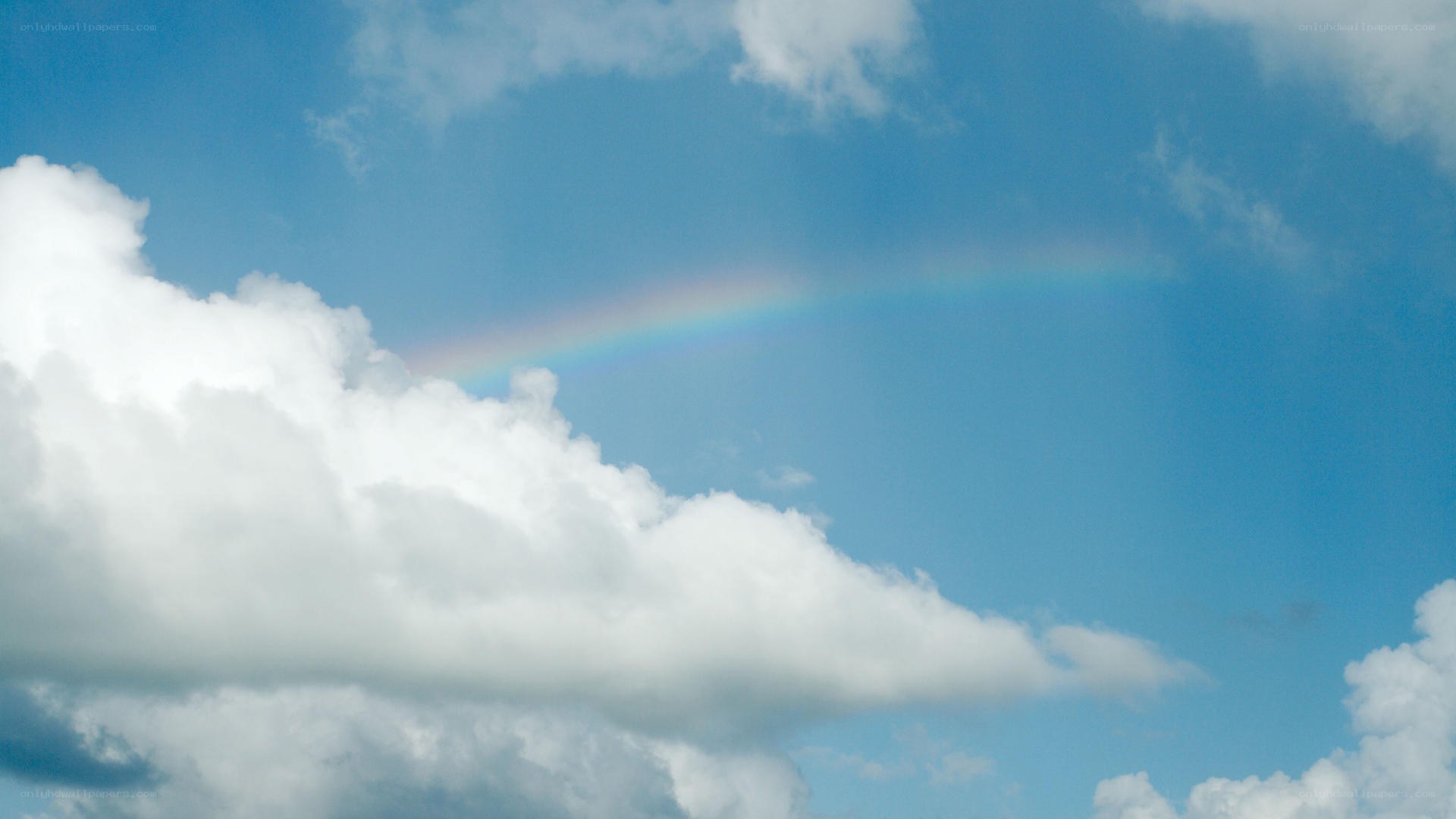 Rainbow in blue sky