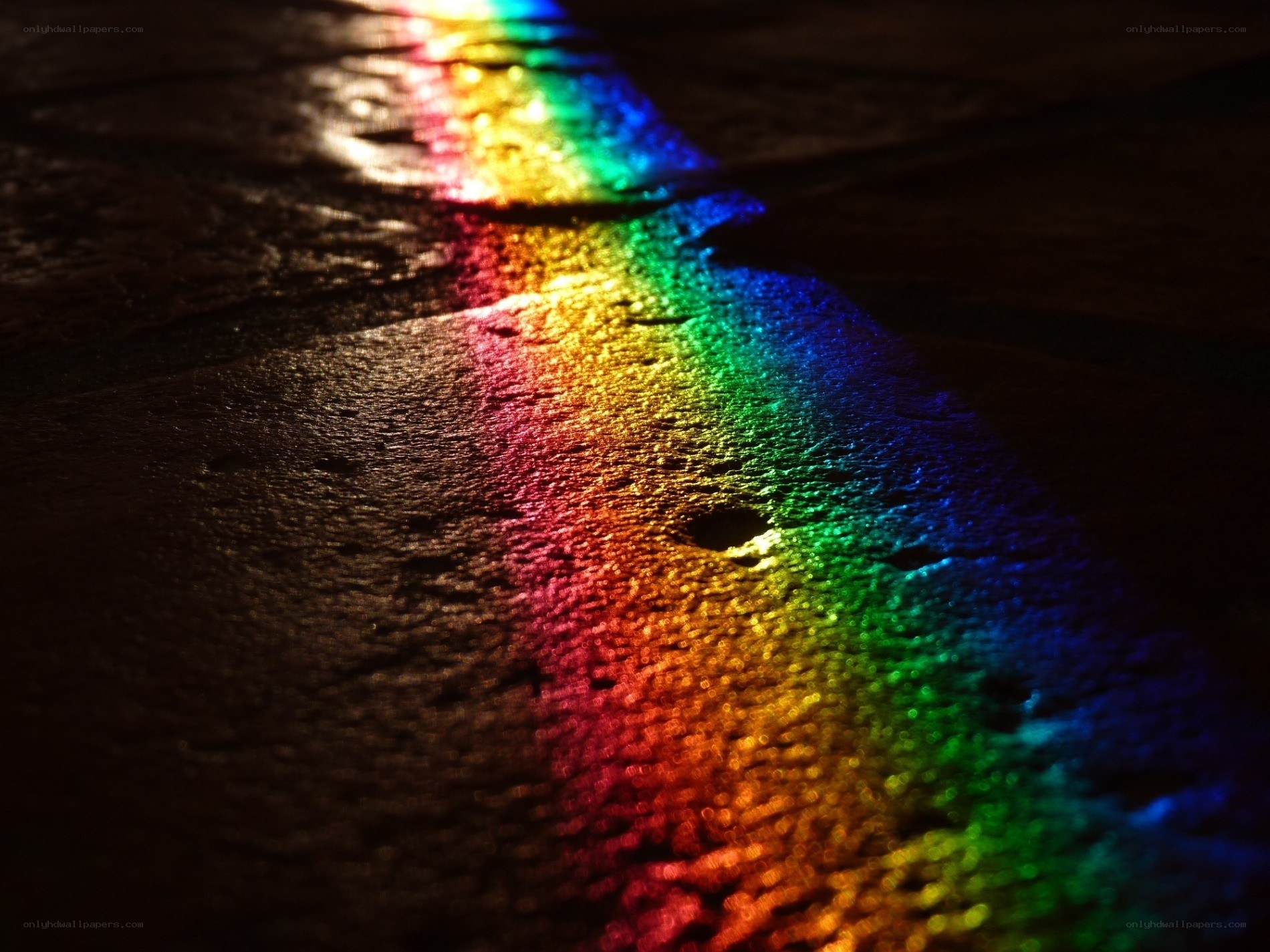 rainbow light on wet pavement