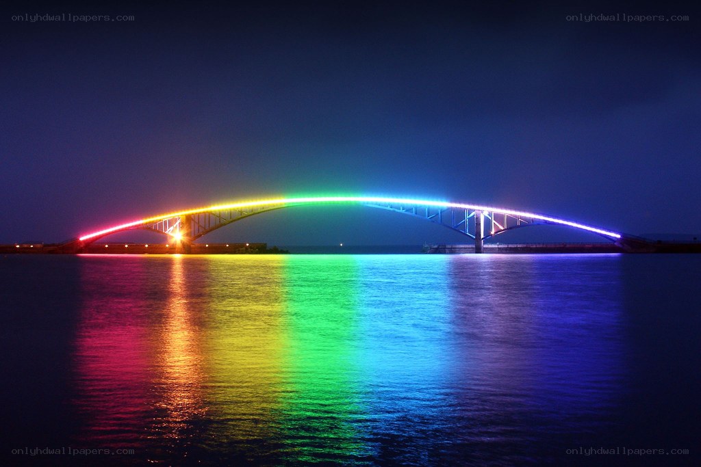 Rainbow-lit bridge at night