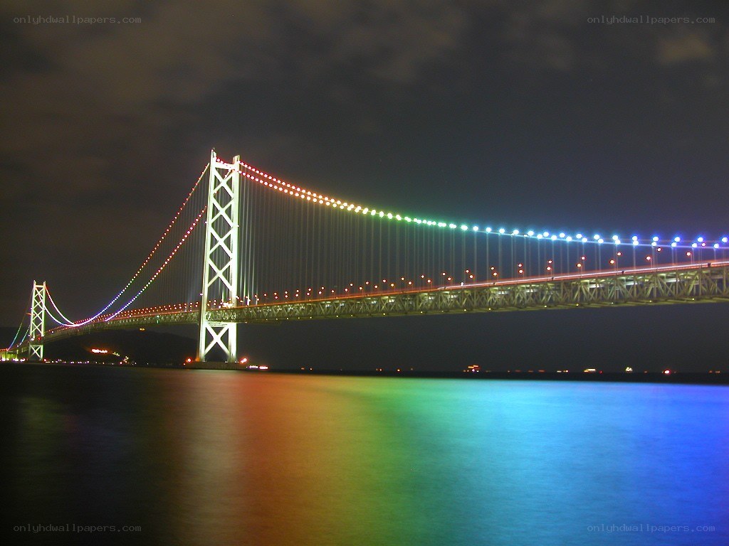 Rainbow-lit suspension bridge at night