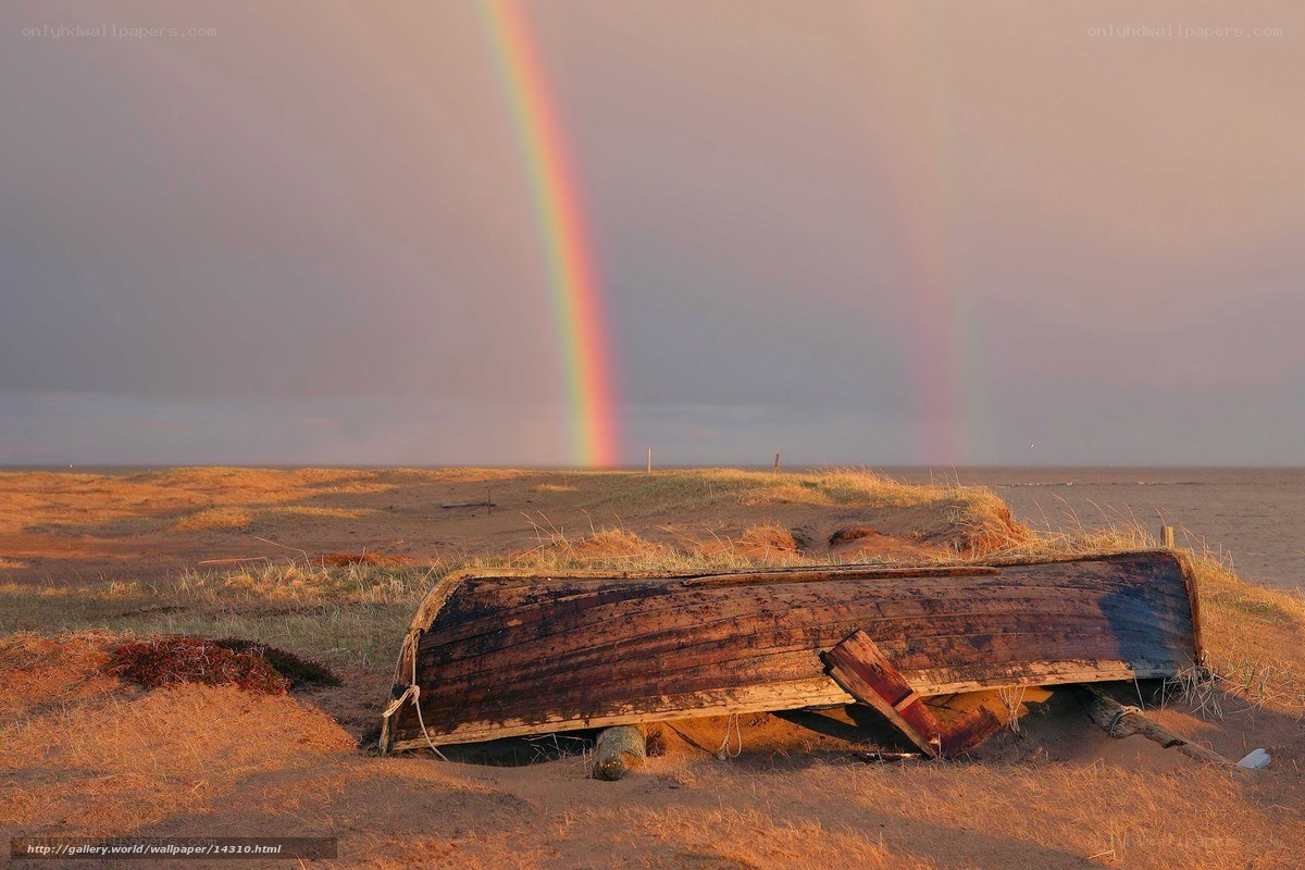 Rainbow over a beached boat