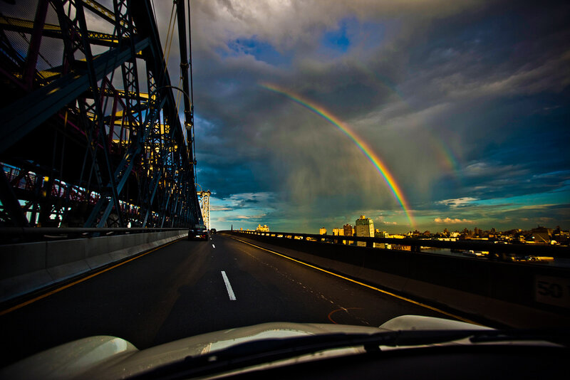 Rainbow over a city bridge
