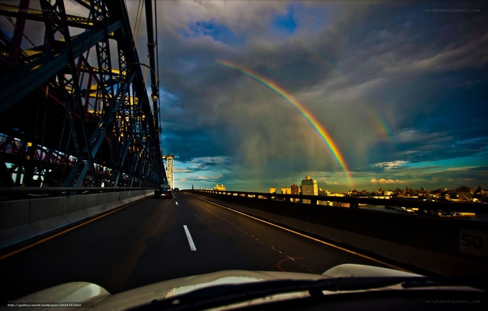 Rainbow over a city bridge