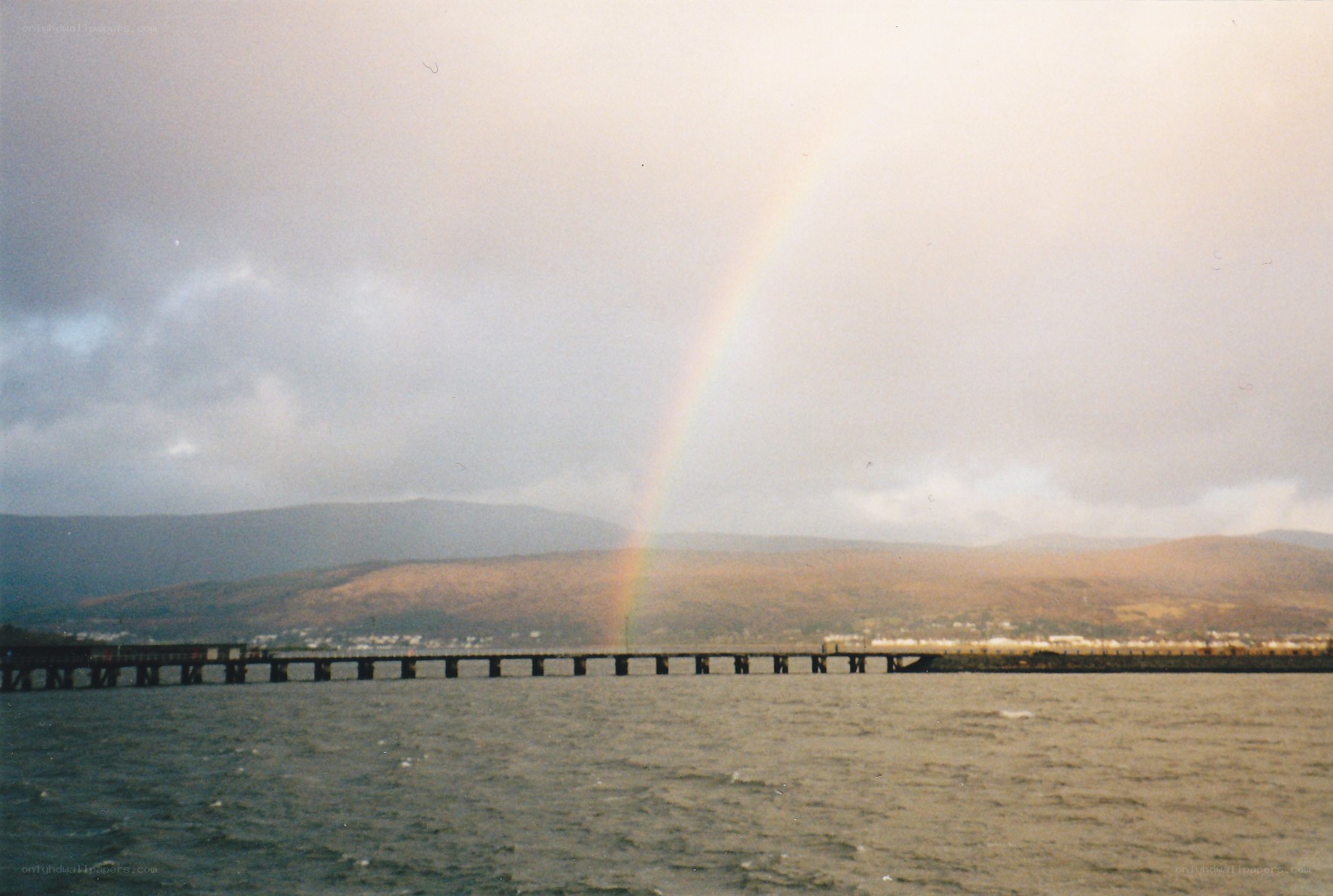 Rainbow over a coastal pier