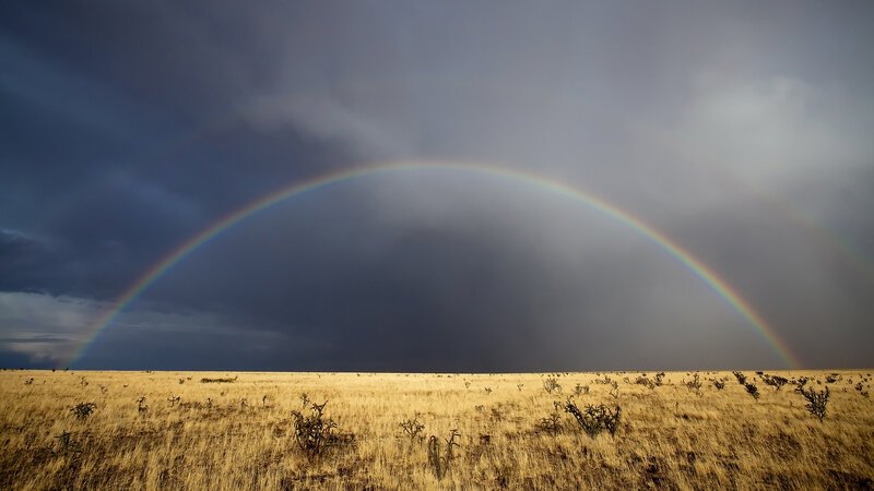 Rainbow over a desert plain