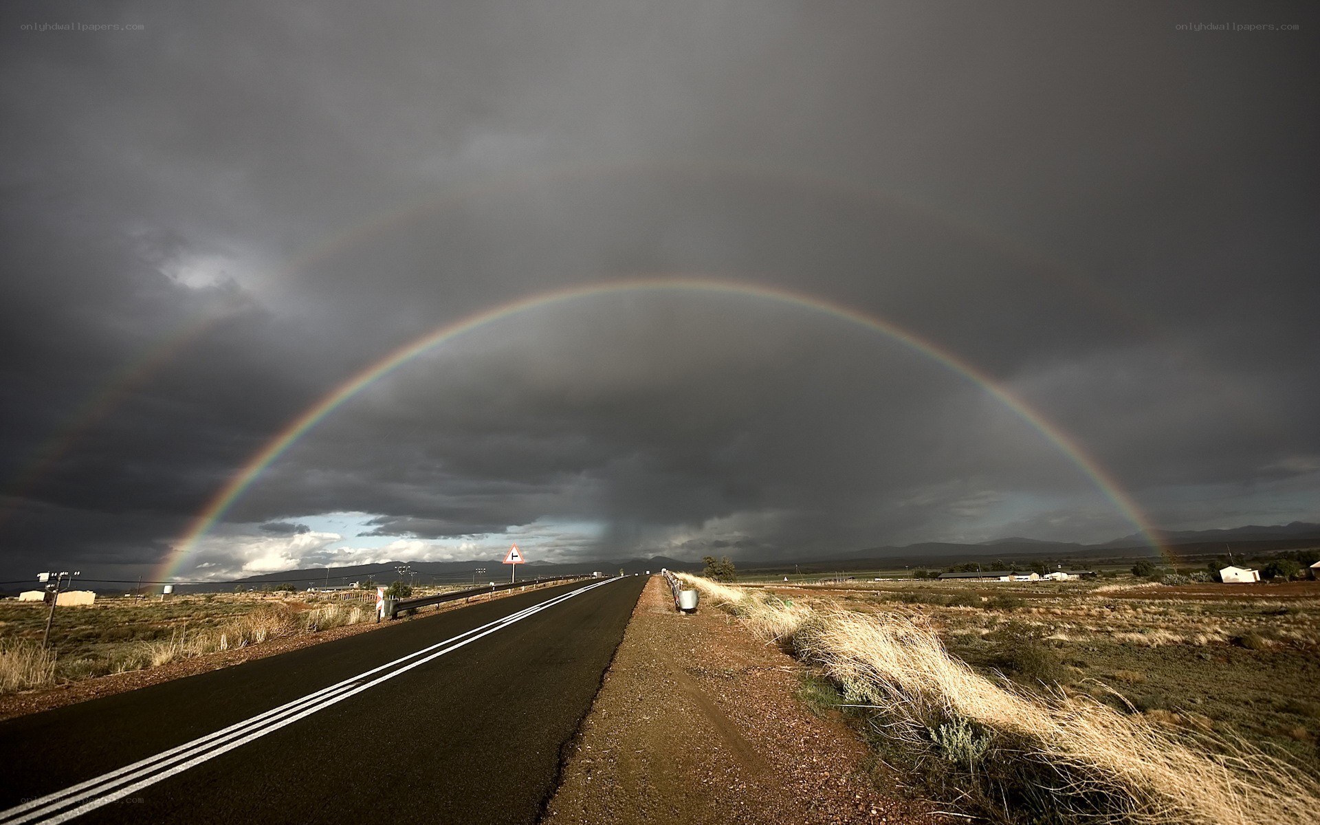 Rainbow over a desert road