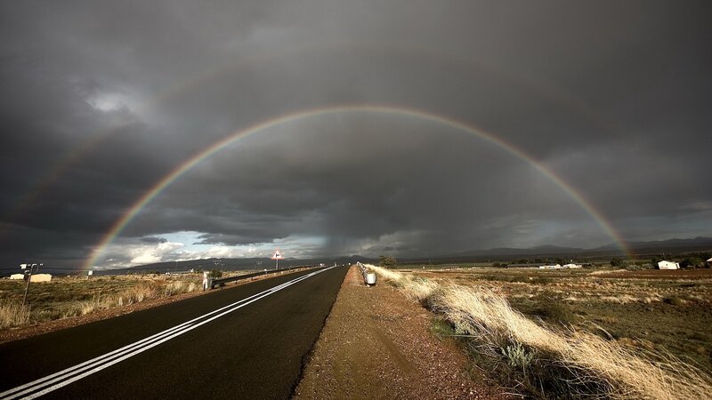 Rainbow over a desert road