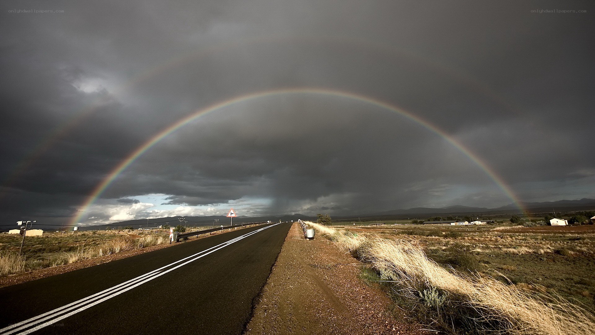 Rainbow over a desert road