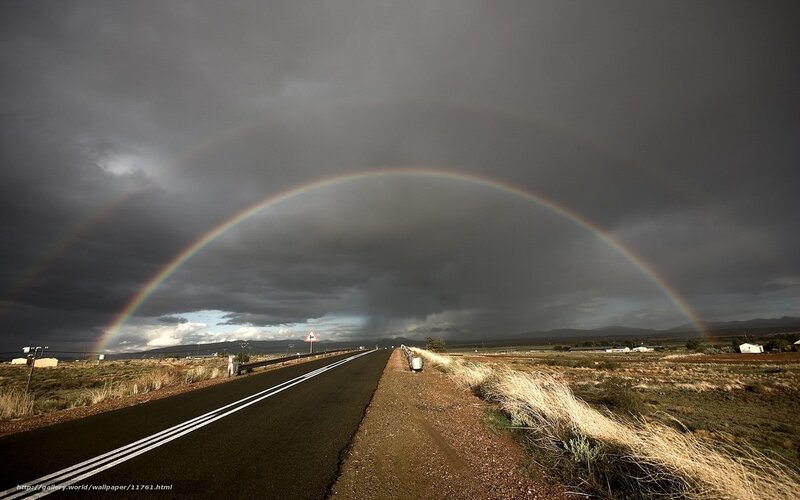 Rainbow over a desert road