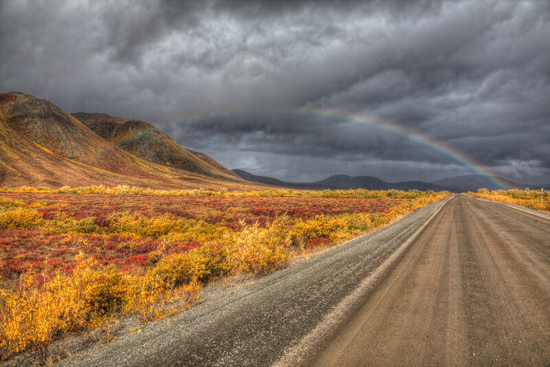 Rainbow over a gravel road