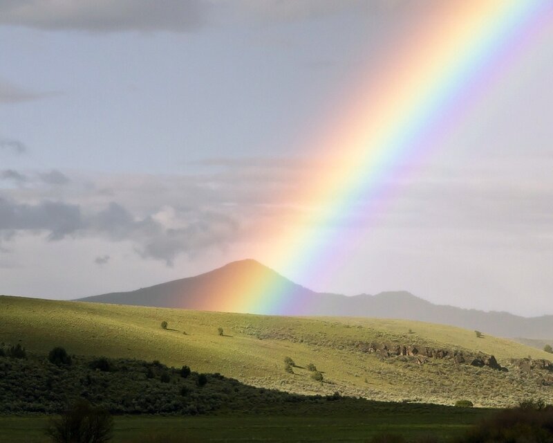 Rainbow over a green hill