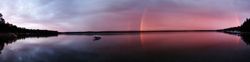 Rainbow over a lake at dusk