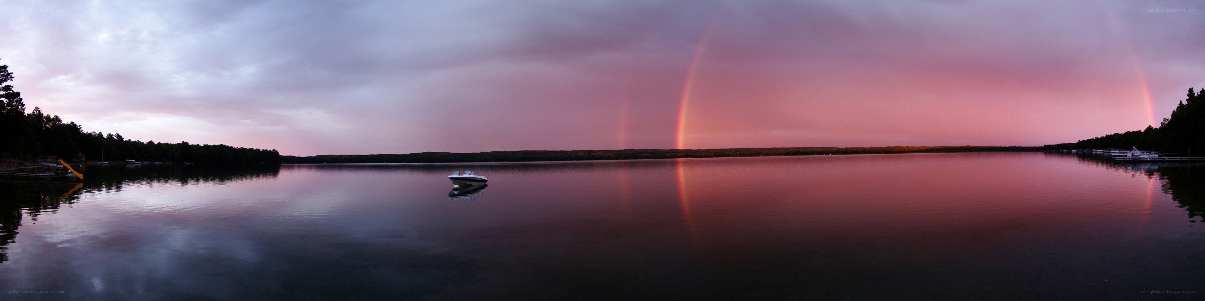Rainbow over a lake at dusk