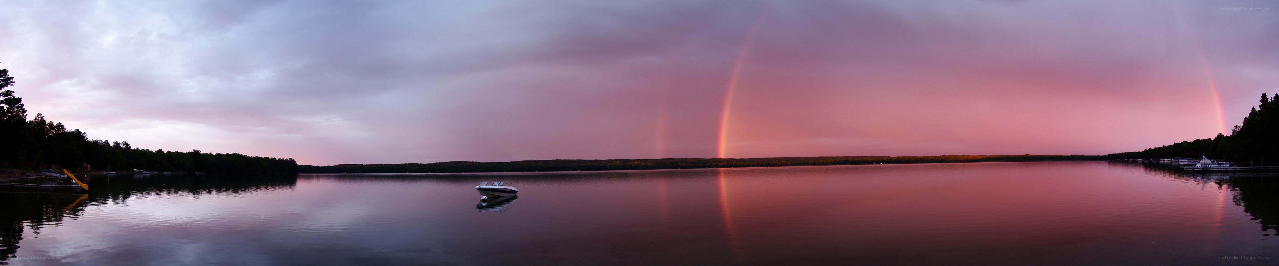Rainbow over a lake at dusk
