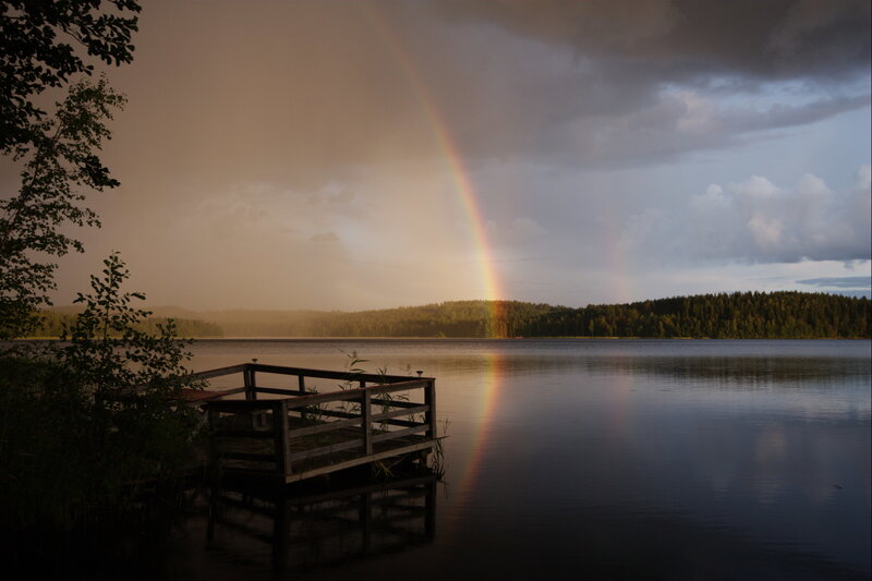 Rainbow over a lake at dusk