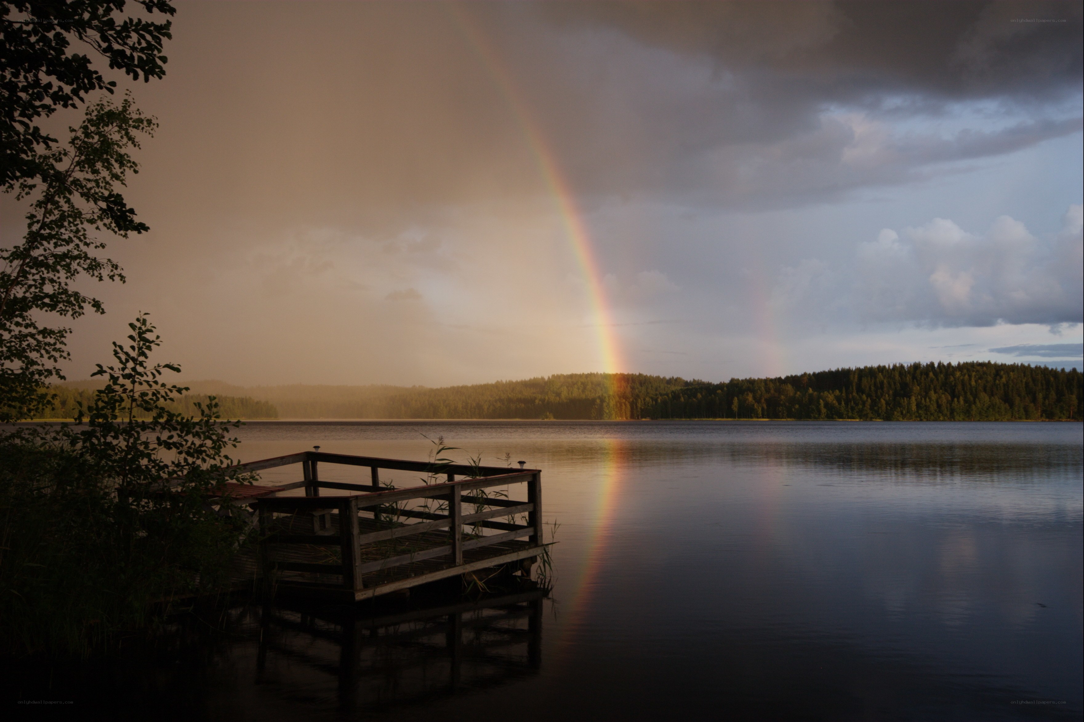Rainbow over a lake at dusk