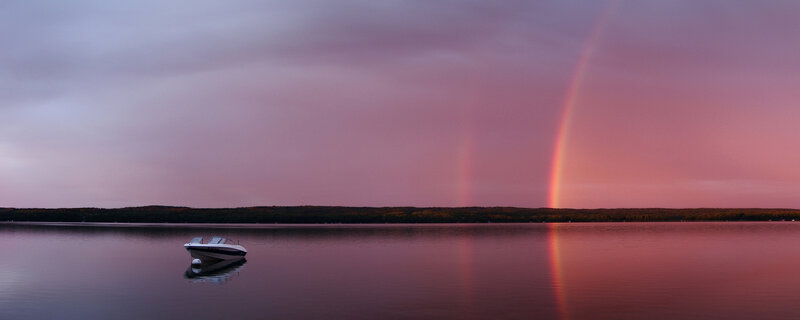 Rainbow over a lake at dusk