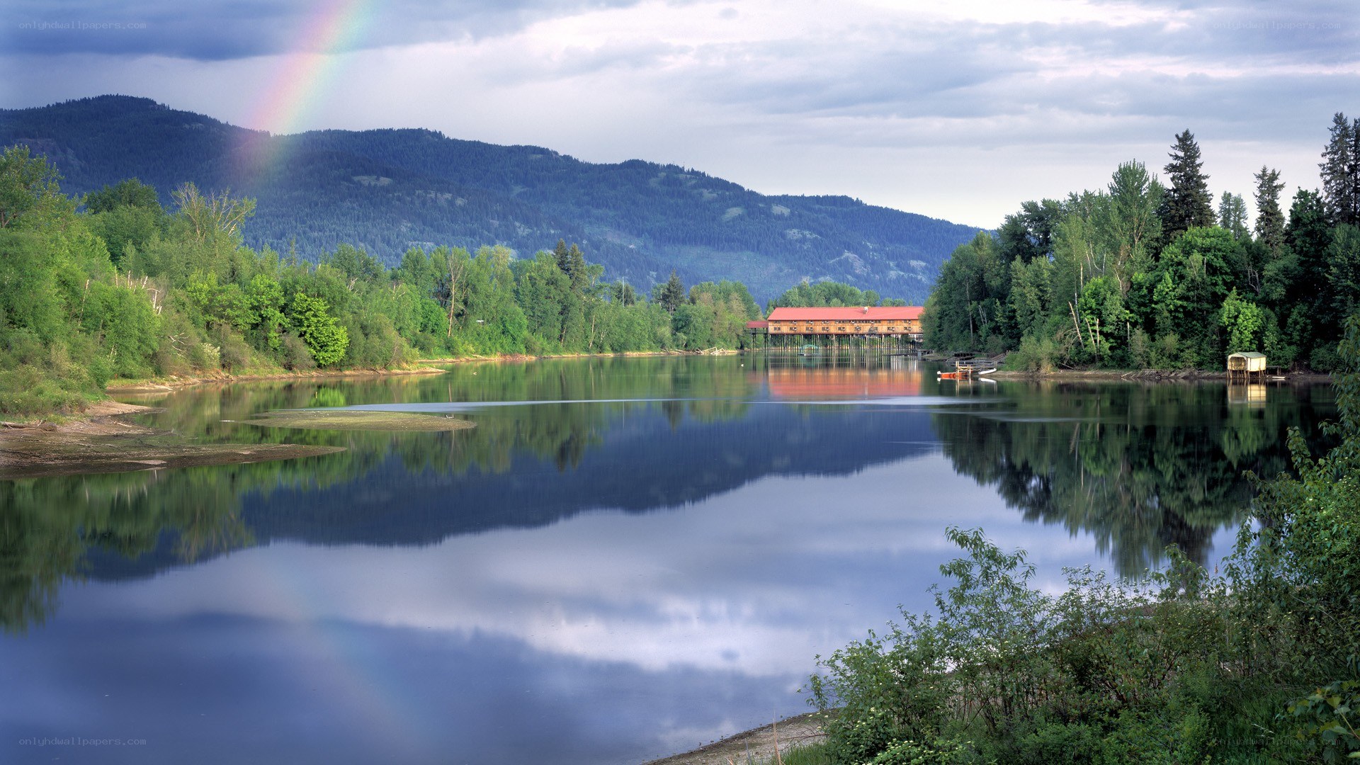 Rainbow over a lake with mountains