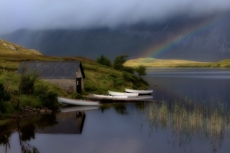 Rainbow over a lakeside cabin