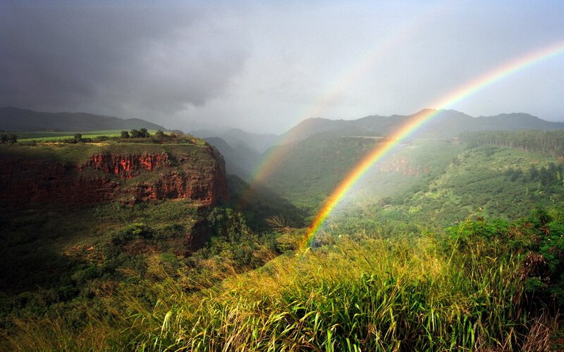 Rainbow over a lush valley