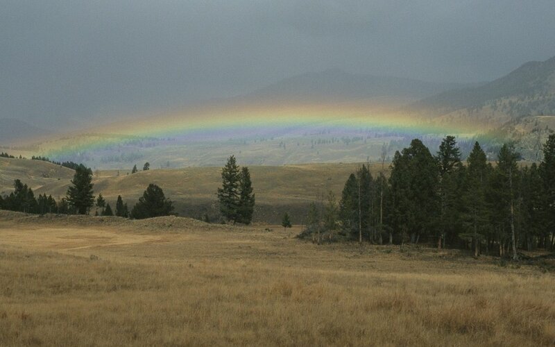 Rainbow over a mountain valley